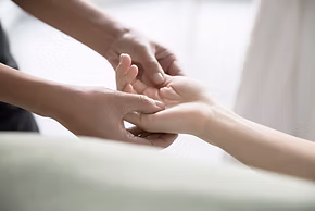 Therapist performing reflexology foot massage in a calming wellness setting